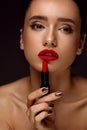 Beautiful Woman With Bright Red Lips And Lipstick In Hand Royalty Free Stock Photo