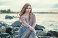 Beautiful woman with brown hair on ocean coast, romantic lifestyle portrait Royalty Free Stock Photo