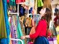 Beautiful woman is browsing through the colorful clothes Royalty Free Stock Photo