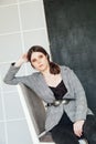 Beautiful fashionable woman brunette clothes business portrait costume in photo studio