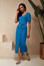 Beautiful woman brunette hair tanned skin makeup cosmetic wear fashion clothes summer collection blue knitted cotton dress on