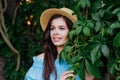 Beautiful woman brunette outdoors. Perfect girl on green leaves background outdoor Royalty Free Stock Photo