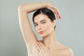 Beautiful woman brunette showing her armpit on gray background Royalty Free Stock Photo