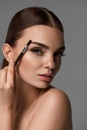 Beautiful Woman Brushing Eyebrows With Brow Tool Royalty Free Stock Photo