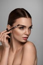 Beautiful Woman Brushing Eyebrows With Brow Tool Royalty Free Stock Photo
