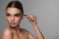 Beautiful Woman Brushing Eyebrows With Brow Tool Royalty Free Stock Photo