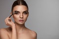 Beautiful Woman Brushing Eyebrows With Brow Tool Royalty Free Stock Photo