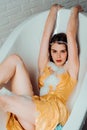 Beautiful woman in a bubble bath. Woman in the bathroom. Sexy vogue woman face, sensual beauty girl model. Royalty Free Stock Photo