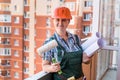 Beautiful woman builder posing with blueprints in rolls Royalty Free Stock Photo