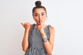 Beautiful woman with bun wearing casual dresss standing over isolated white background asking to be quiet with finger on lips Royalty Free Stock Photo