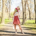 Beautiful woman with bunch of flowers outdoors Royalty Free Stock Photo