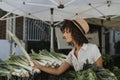 Beautiful woman buying vegetables at a farmers market Royalty Free Stock Photo