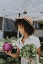 Beautiful woman buying vegetables at a farmers market Royalty Free Stock Photo
