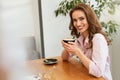 Beautiful Woman In Cafe Drinking Coffee Royalty Free Stock Photo