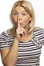 Beautiful woman calls for silence, keeps finger at lips, close-up Royalty Free Stock Photo