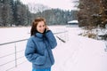 beautiful woman calmly waiting, talking on the phone in a snowy landscape Royalty Free Stock Photo