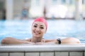 Beautiful woman cap smiling looking to camera at border of swimming pool Royalty Free Stock Photo