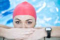 Beautiful woman cap smiling looking to camera at border of swimming pool Royalty Free Stock Photo