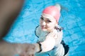 Beautiful woman cap smiling looking to camera at border of swimming pool Royalty Free Stock Photo