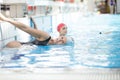 Beautiful woman cap smiling looking to camera at border of swimming pool Royalty Free Stock Photo