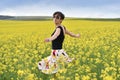 Beautiful woman cheering in rapeseed field and enjoying summer Royalty Free Stock Photo