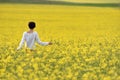 Beautiful woman cheering in rapeseed field and enjoying summer Royalty Free Stock Photo