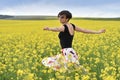 Beautiful woman cheering in rapeseed field and enjoying summer Royalty Free Stock Photo