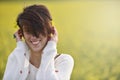 Beautiful woman cheering in rapeseed field and enjoying summer Royalty Free Stock Photo