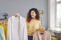 Beautiful woman choosing clothes on rack at home Royalty Free Stock Photo