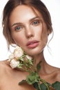 Beautiful woman with classic nude make-up, light hairstyle and flowers. Beauty face. Royalty Free Stock Photo