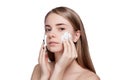 Beautiful woman cleaning face with foam treatment light background Royalty Free Stock Photo