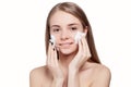 Beautiful woman cleaning face with foam treatment light background Royalty Free Stock Photo