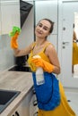 Beautiful woman cleaning her kitchen hood from dust Royalty Free Stock Photo