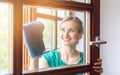 Beautiful woman cleaning the windows in spring Royalty Free Stock Photo