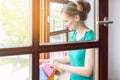 Beautiful woman cleaning the windows in spring Royalty Free Stock Photo