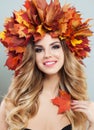 Beautiful woman with clear skin, healty curly hairstyle and autumn leaves Royalty Free Stock Photo