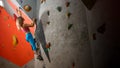 Beautiful Woman Climber Bouldering in the Climbing Gym. Extreme Sport and Indoor Climbing Concept Royalty Free Stock Photo
