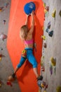 Woman Climber Practicing Rock-climbing in the Bouldering Gym. Extreme Sport and Indoor Climbing Concept Royalty Free Stock Photo
