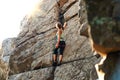 Beautiful Woman Climbing on the Rock at Foggy Sunset in the Mountains. Adventure and Extreme Sport Concept Royalty Free Stock Photo