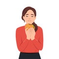 Beautiful woman with closed eyes is eating a cheeseburger. Fastfood