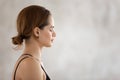 Beautiful woman with closed eyes practicing yoga, meditating, profile view Royalty Free Stock Photo