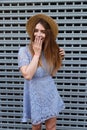 Beautiful woman closing her mouth by hand while laughing. Royalty Free Stock Photo