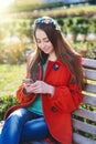 Beautiful woman coat sitting on bench in the city