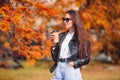 Fall concept - beautiful woman in autumn park under fall foliage Royalty Free Stock Photo