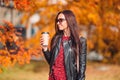 Fall concept - beautiful woman in autumn park under fall foliage Royalty Free Stock Photo