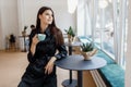 Beautiful women in a coffee shop with a cup of coffee Royalty Free Stock Photo