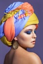 Beautiful woman with colored headwear and blue makeup. Royalty Free Stock Photo