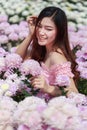Beautiful woman in chrysanthemum glower garden