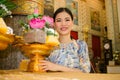 Woman make offering in temple, Thailand