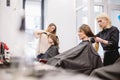 Beautiful woman combing wet hair. stylist brushing woman hair in salon. Hairdresser Serving Customer. Professional Young Royalty Free Stock Photo